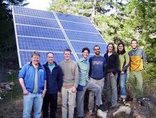 A group of students pose with the Rock Creek PV array